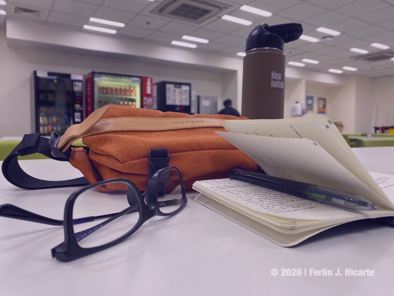 Photo of the sling on a table with my glasses and notebook.